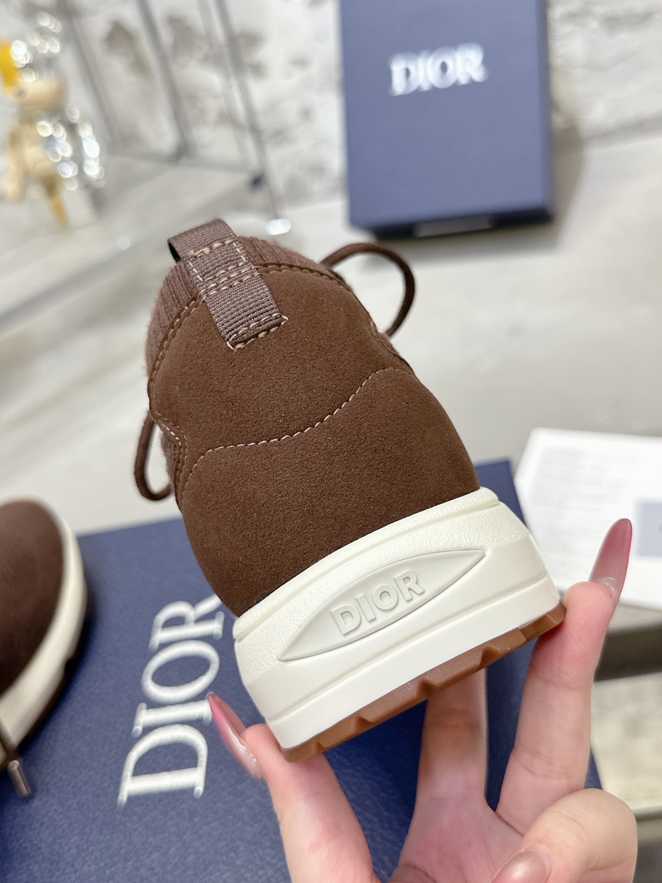 Brown knit sneaker with heel label and white outsole with Dior branding