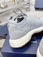 Unisex light gray knit sneakers with lace-up detail and cream sole