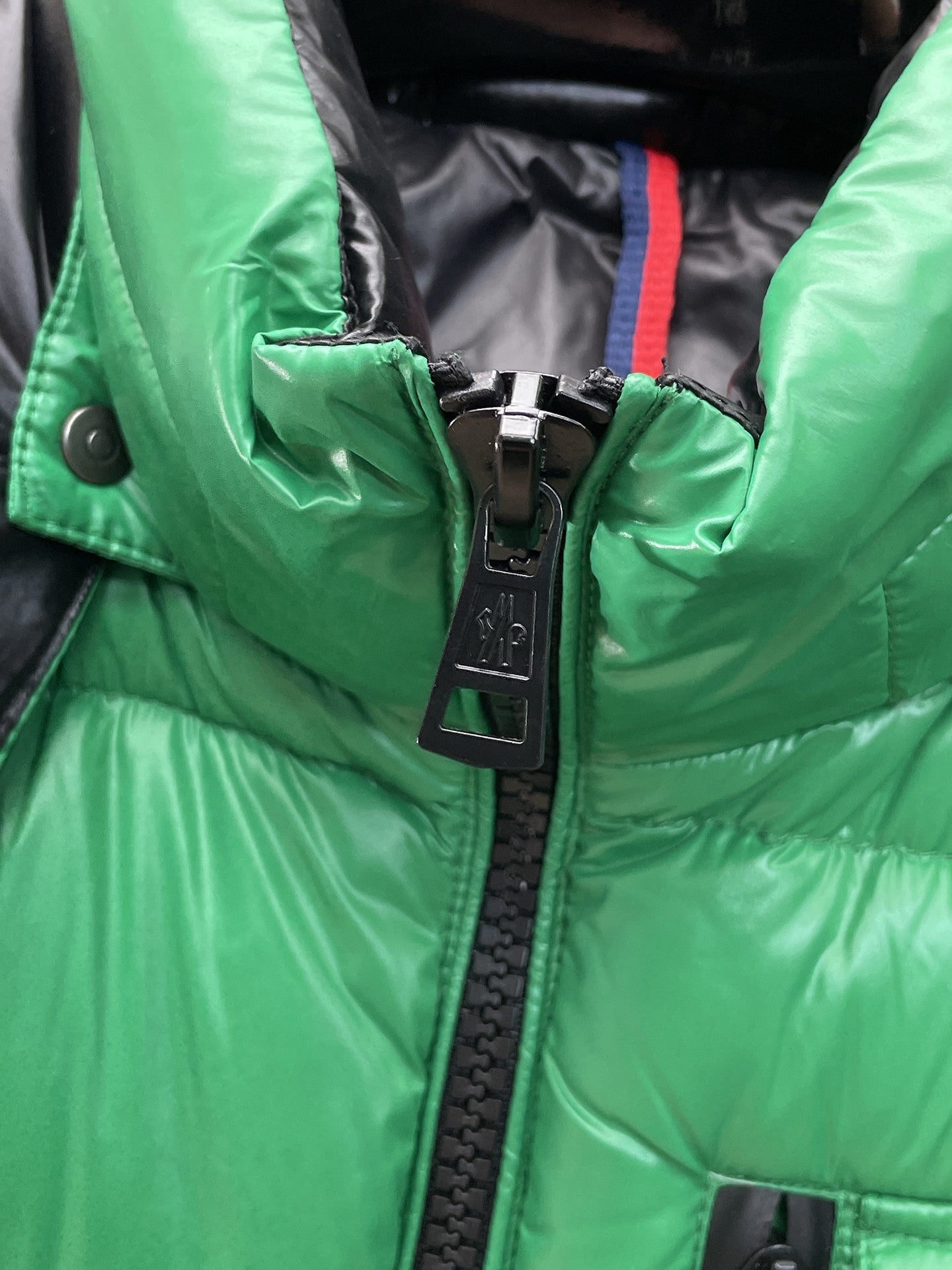 Green long jacket with front zip and black zipper pull