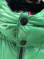 Green puffer vest collar with black button closure and black interior lining