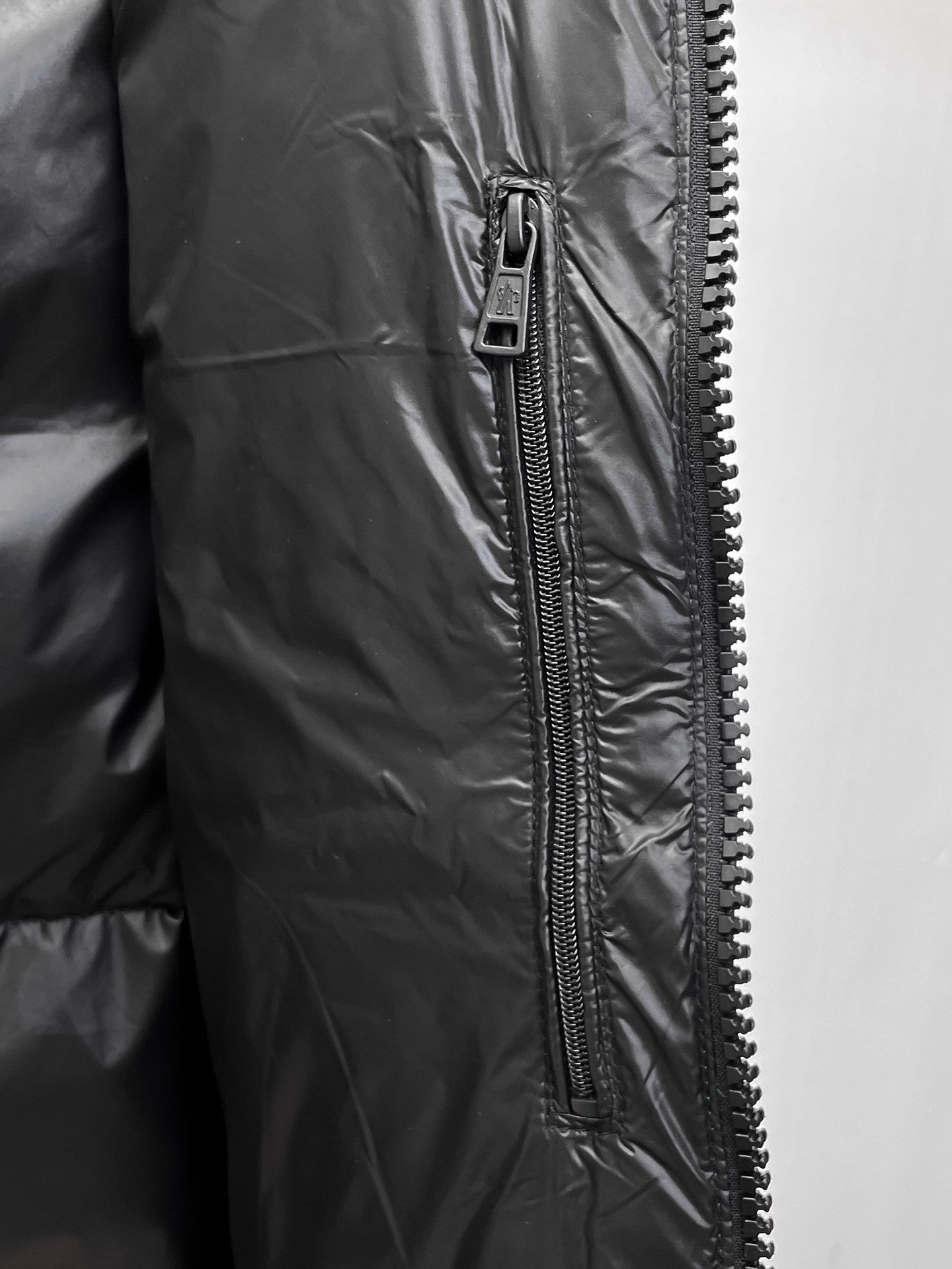 Dark gray long jacket with front zipper and zipper pull tab