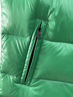 Green puffer vest lower front section with vertical zipper and small label
