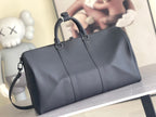 Men's Louis Vuitton duffel bag with structured sides, top handles, and detachable strap