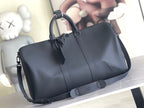 Men's Louis Vuitton duffel bag in dark leather with top handles and shoulder strap