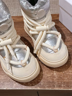 Moncler lace-up sneaker boots detail view of silver panels and cream laces