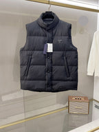 Hooded long puffer vest in dark fabric with front buttons and triangular logo patch
