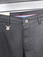 Black Burberry trouser waistband close-up with button and belt loop