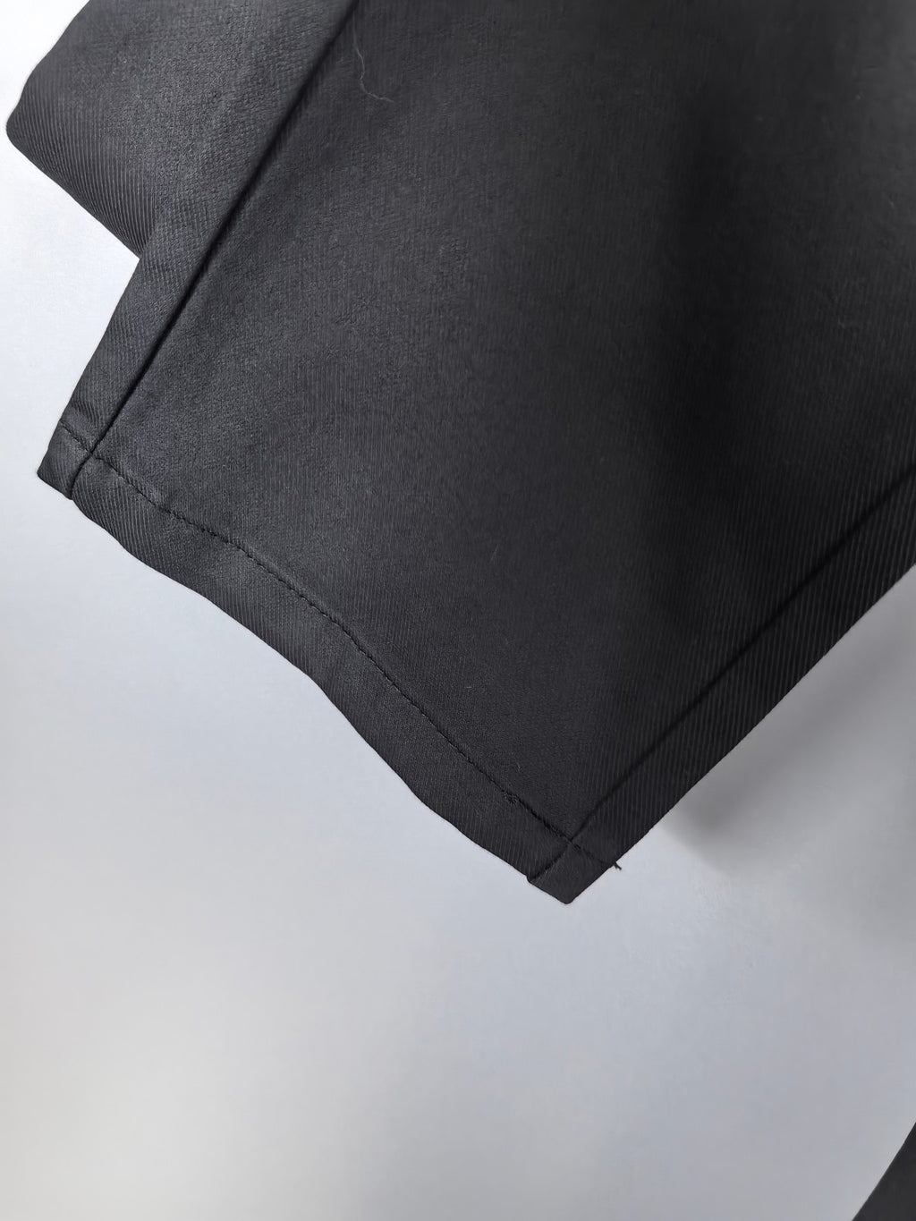 Black Burberry trouser hem with visible stitching