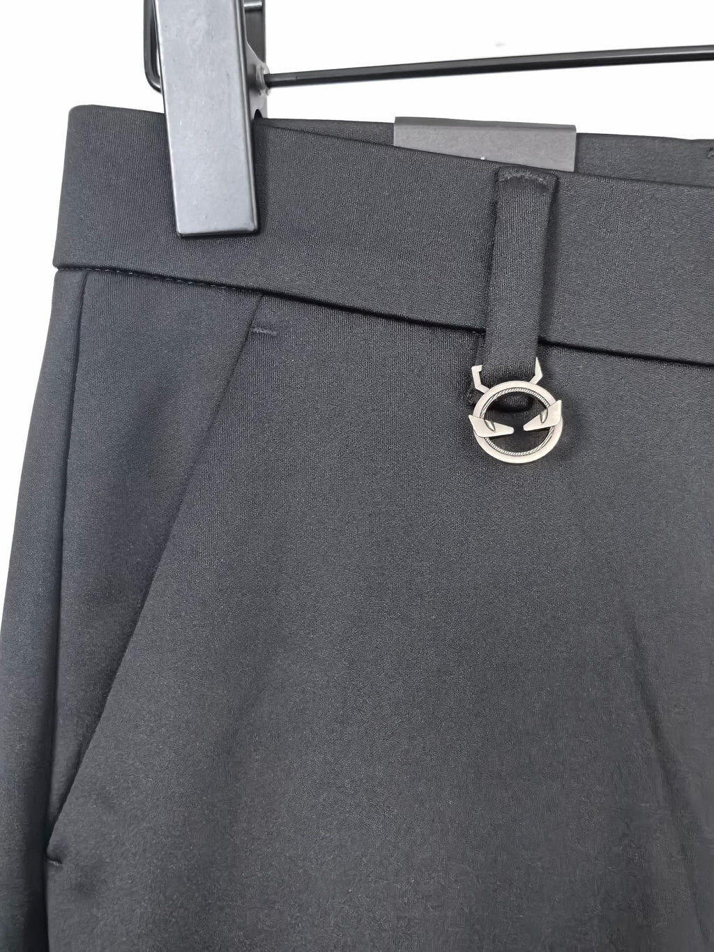 Black trousers with logo d-ring belt detail and slanted side pockets