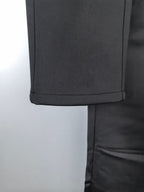 Black trouser hem with stitched cuff and fold seam