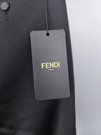Black trousers with hanging FENDI ROMA size tag on belt loop