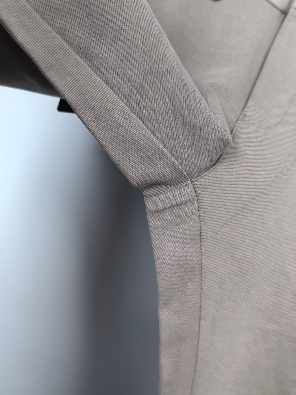 Beige trouser front with crease line and diagonal seam detail