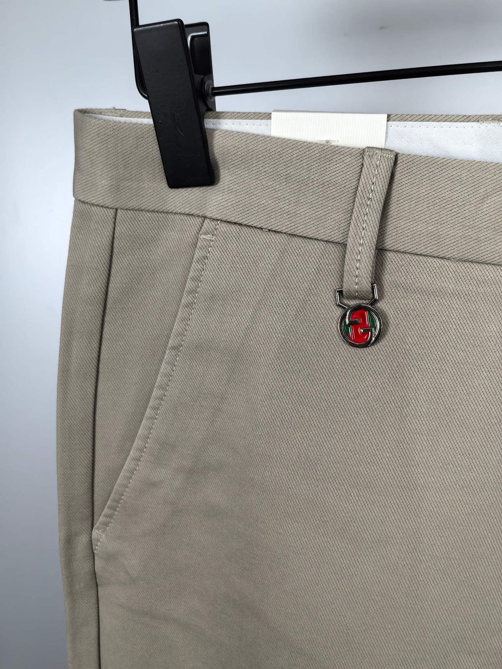 Beige Gucci pants front with side seam detail and GG logo charm