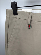 Beige Gucci pants front with side seam detail and GG logo charm