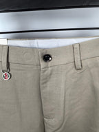 Beige Gucci pants waistband with black button and belt loops