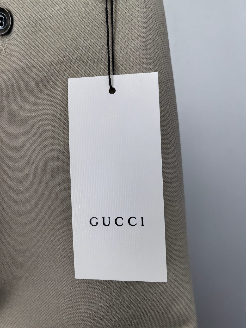 Beige Gucci pants with hanging retail tag and waist stitching
