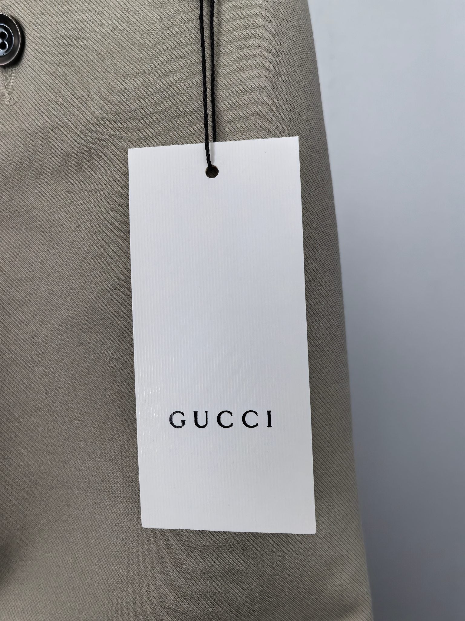 Beige Gucci pants with hanging retail tag and waist stitching