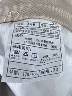 Gucci pants care label with fabric composition and washing symbols