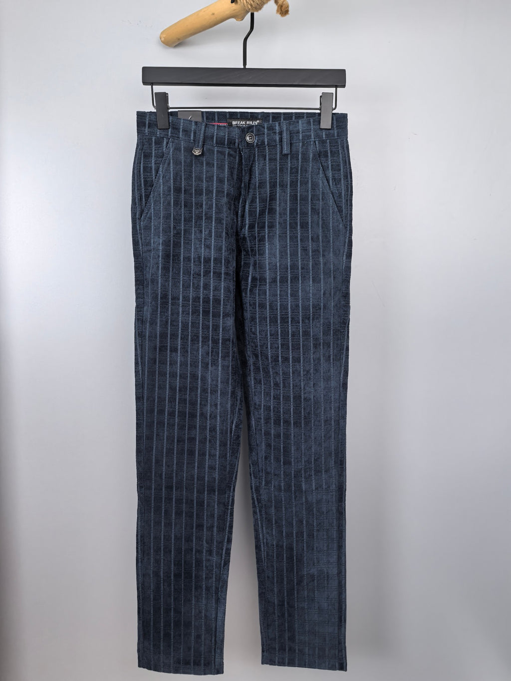 Dark blue check trousers with front button closure and belt loops