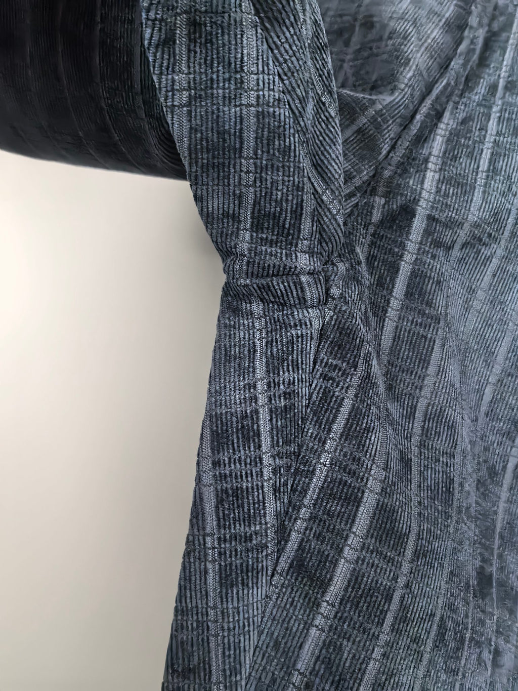 Blue check trousers with stitched pleat seam detail at the thigh