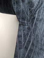 Blue check trousers with stitched pleat seam detail at the thigh