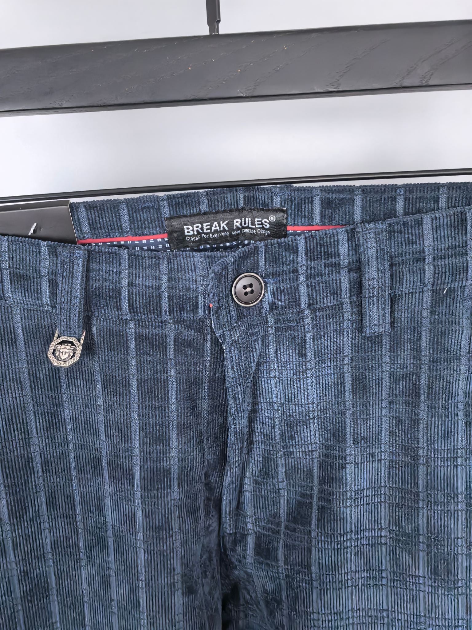 Blue check trousers waistband with button fly and logo patch
