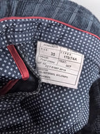 Interior size label inside blue trousers, size 30
