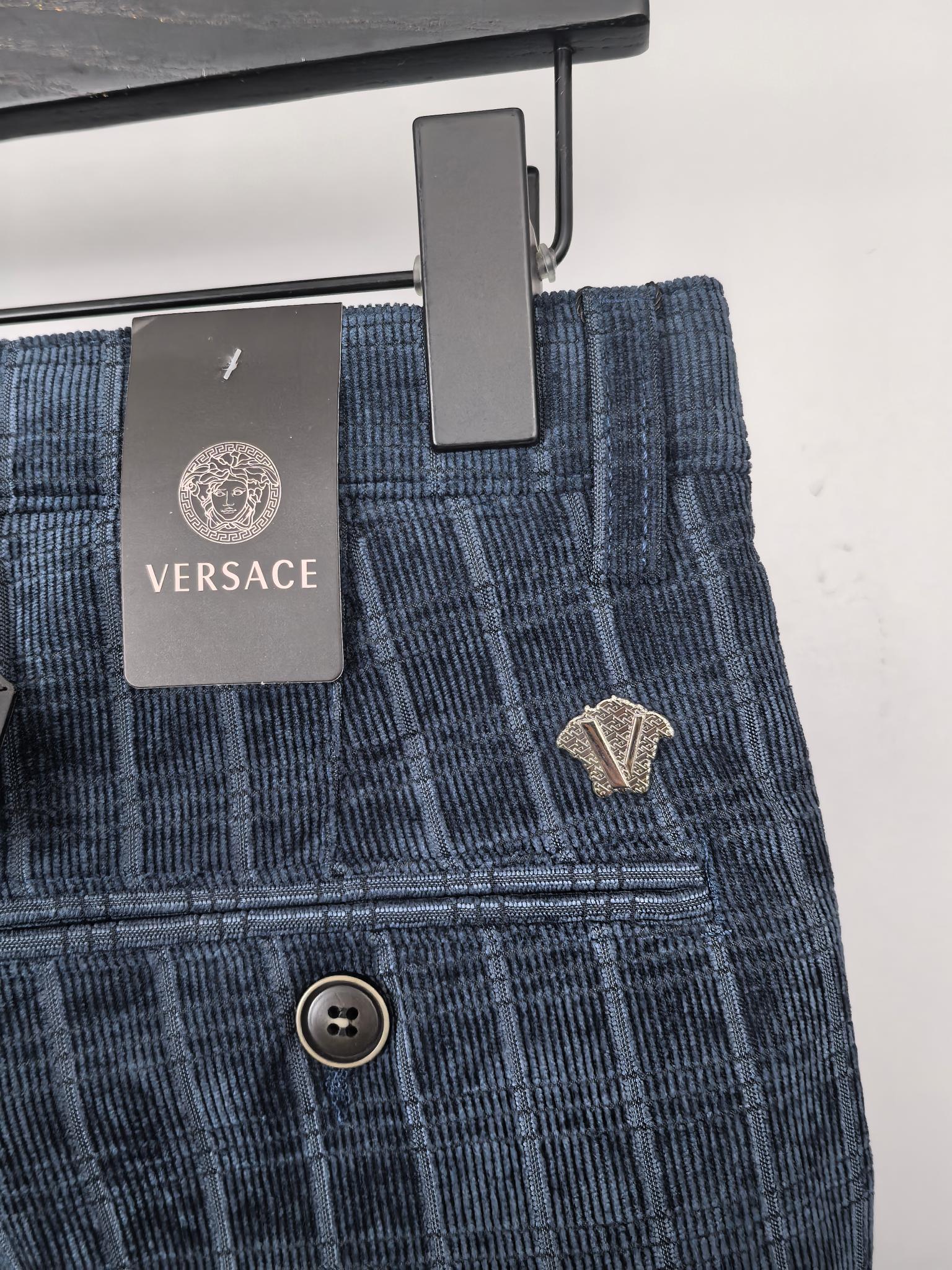 Blue check trousers with VERSACE label, belt loops, and front button