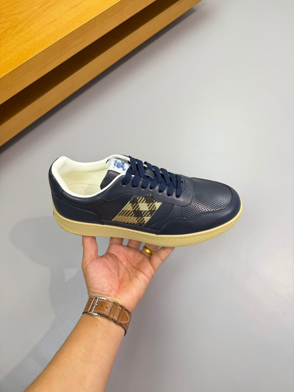 Burberry low-top sneaker in navy with check accent panel and cream-colored sole