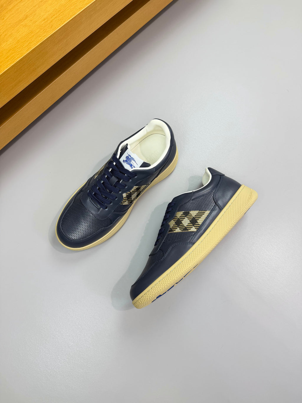 Burberry low-top sneakers in dark navy with check panel inserts and light soles
