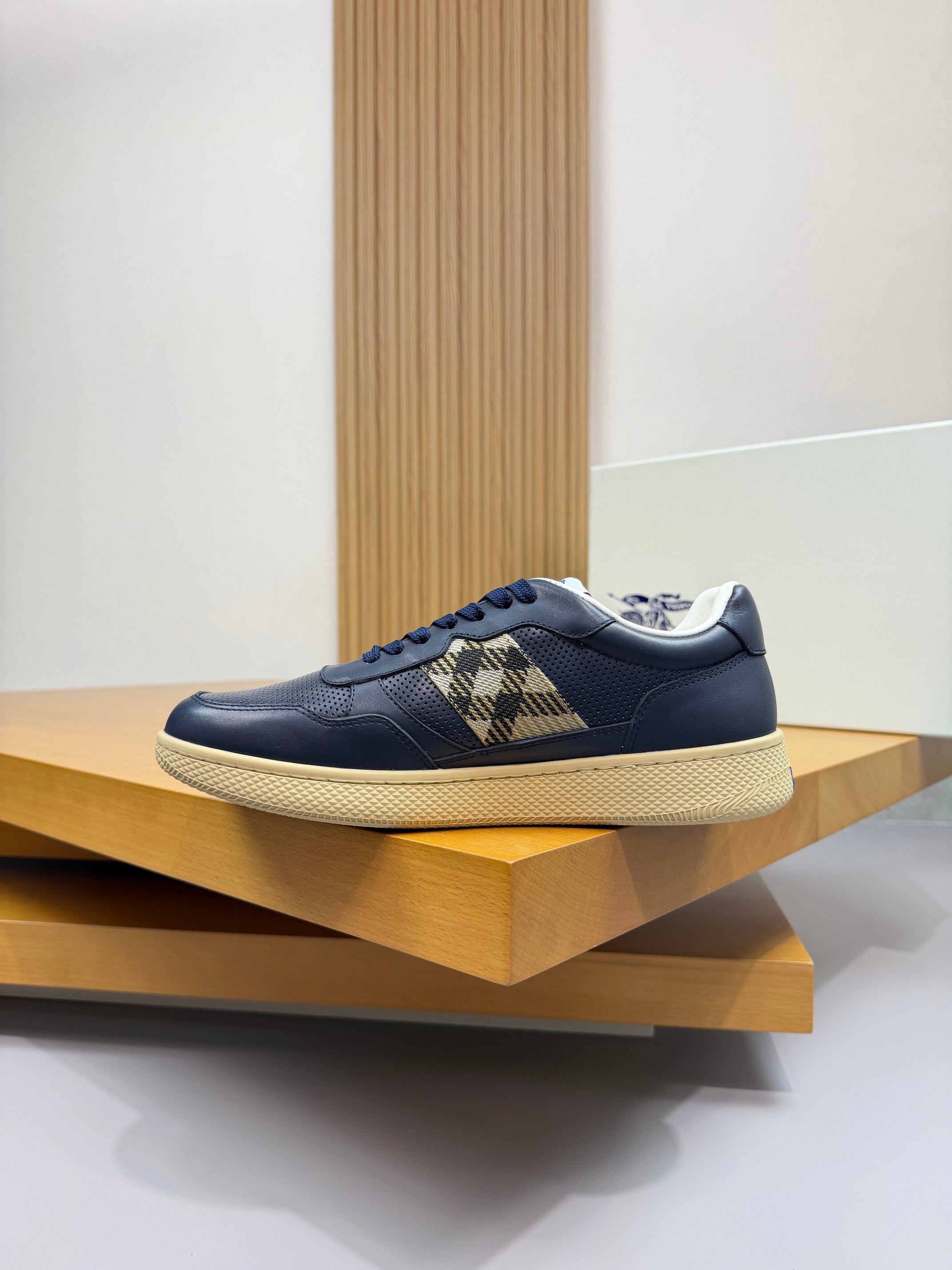 Burberry low-top sneaker in navy with check panel strap and textured white outsole