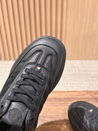 Black Moncler sneaker toe and lace area with small tricolor logo detail.