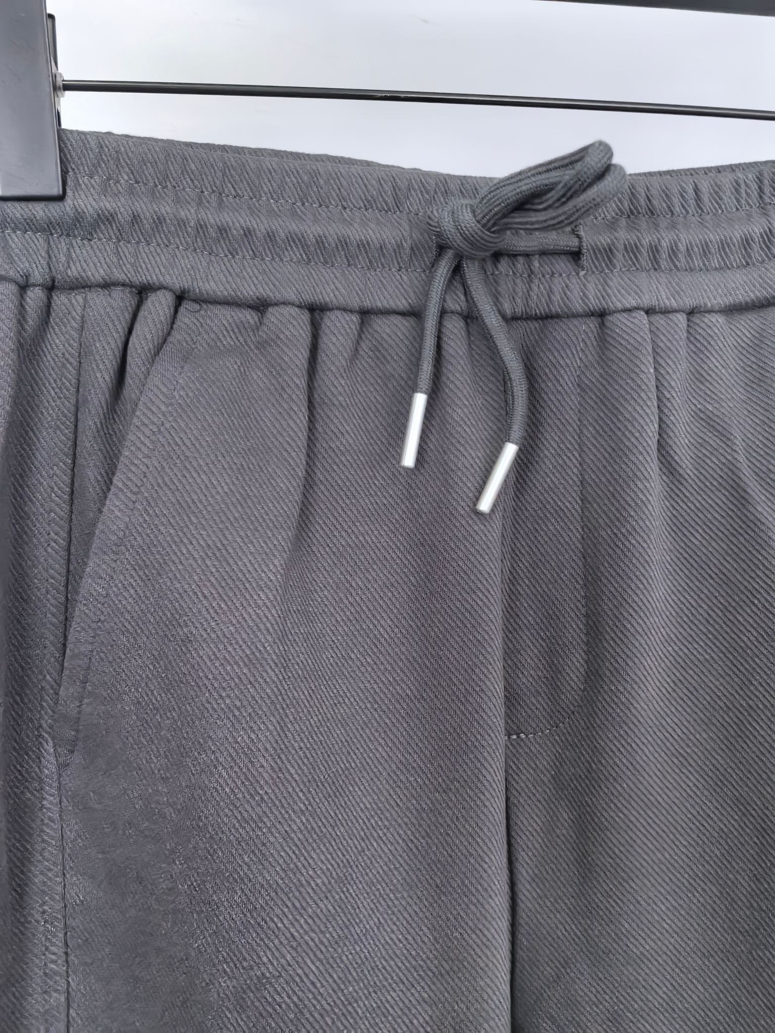 Dark gray Louis Vuitton jogger waistband with drawstring and white cord tips