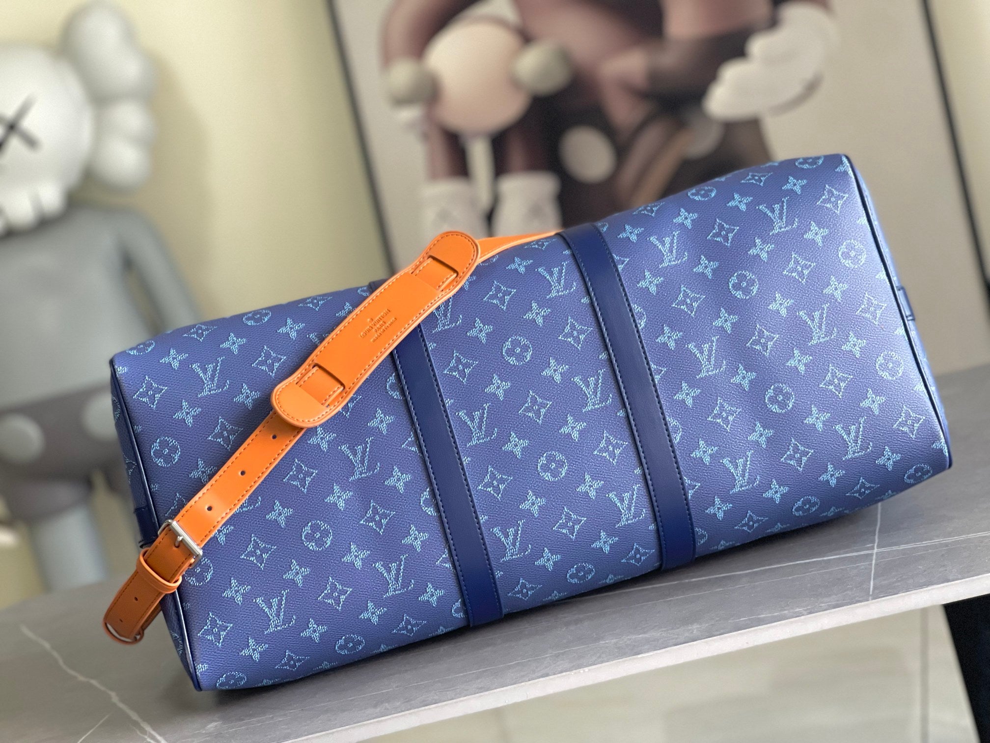 Louis Vuitton duffel bag, blue monogram canvas with orange strap and blue center panel