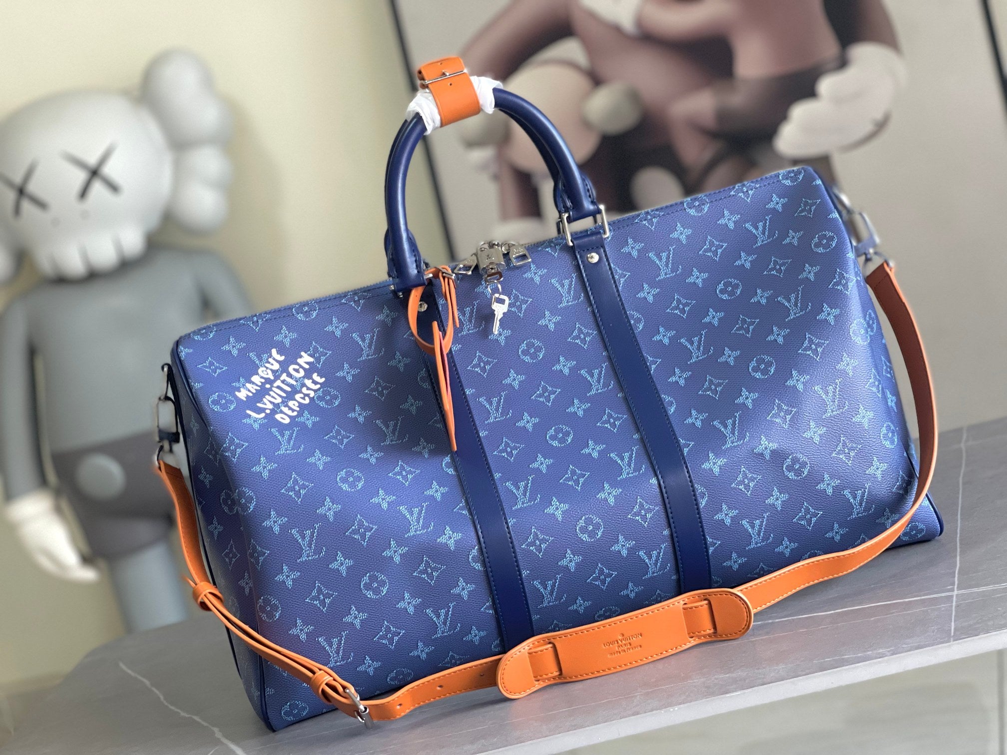 Louis Vuitton men’s duffel bag in blue monogram canvas with orange trim and handles