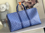 Blue Louis Vuitton duffel bag with monogram pattern, top handles, and orange trim details