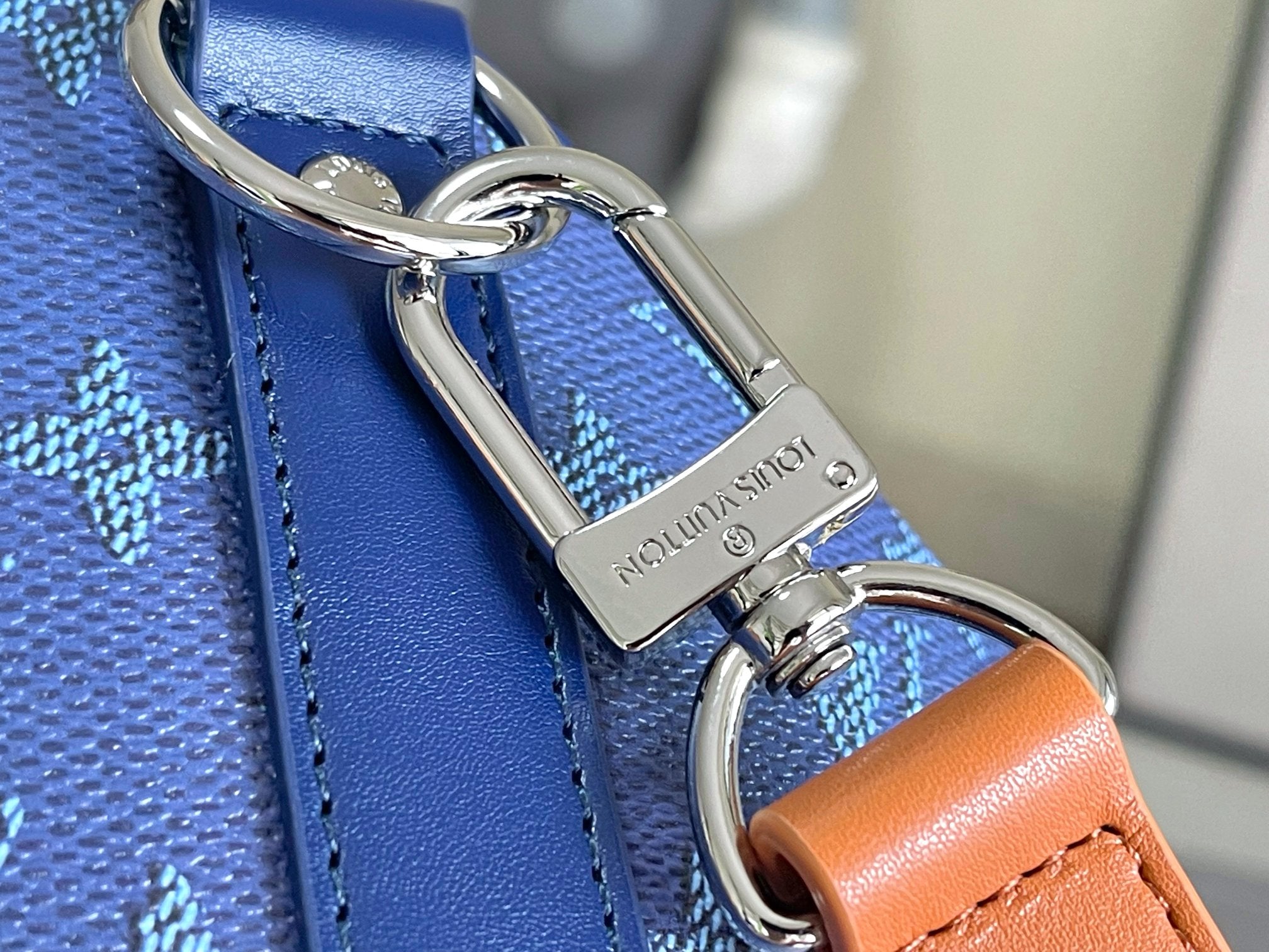 Louis Vuitton monogram bag key ring hardware with blue strap and orange leather loop