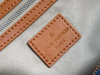 Louis Vuitton label patch on bag, brown leather tag with embossed “Louis Vuitton” text