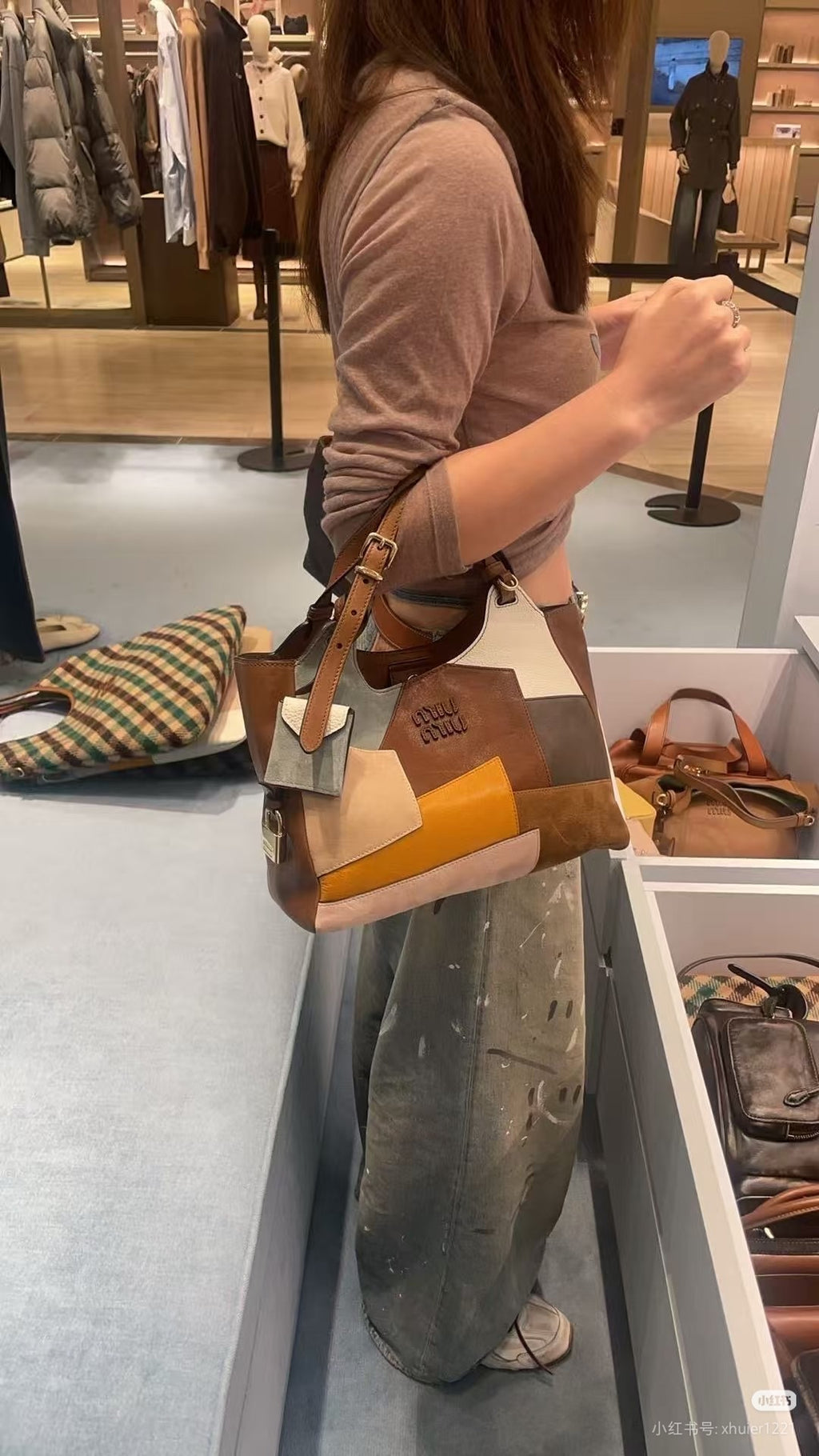 Patchwork tote bag side view with brown handles and multicolor panels, orange accent strip
