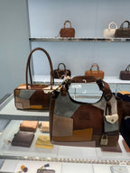 Patchwork tote bag on display shelf with brown, gray, tan and orange panels