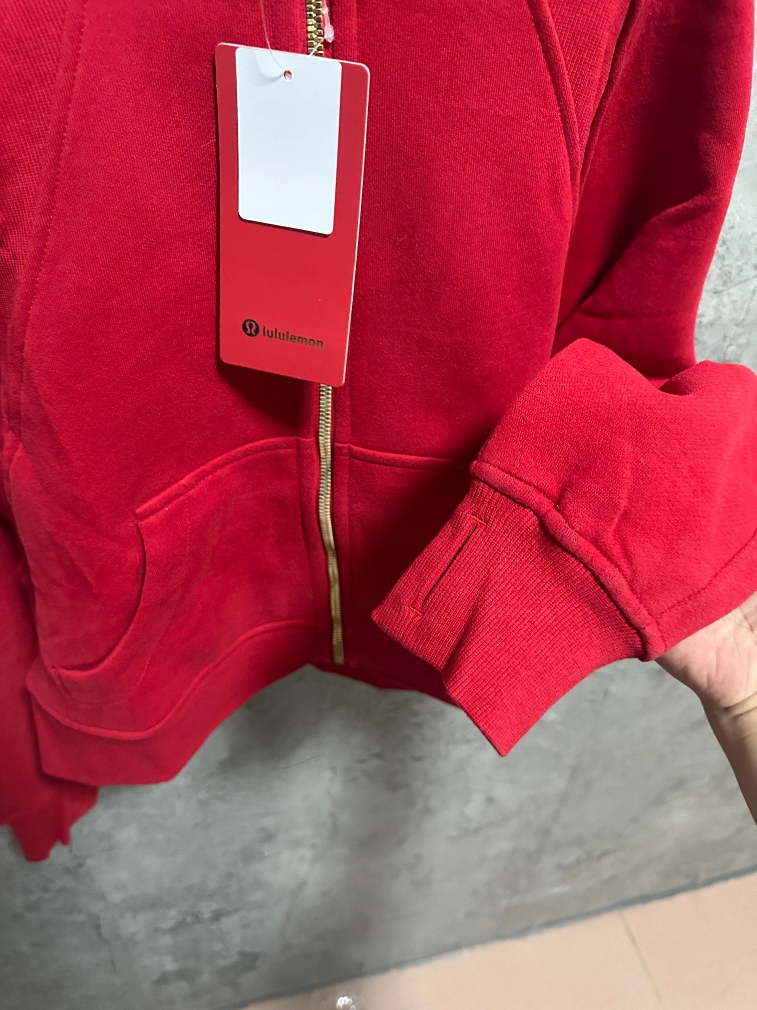 Ralph Lauren red zip hoodie chest view with pouch pockets and ribbed cuffs