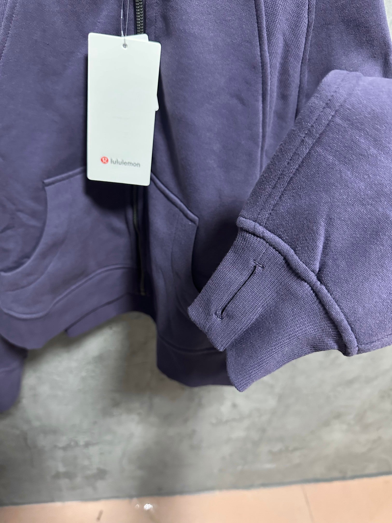 Ralph Lauren zip-up hoodie sleeve and front pocket detail in dark purple