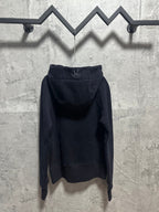 Dark zip-up hoodie with hood and stitched logo on back yoke