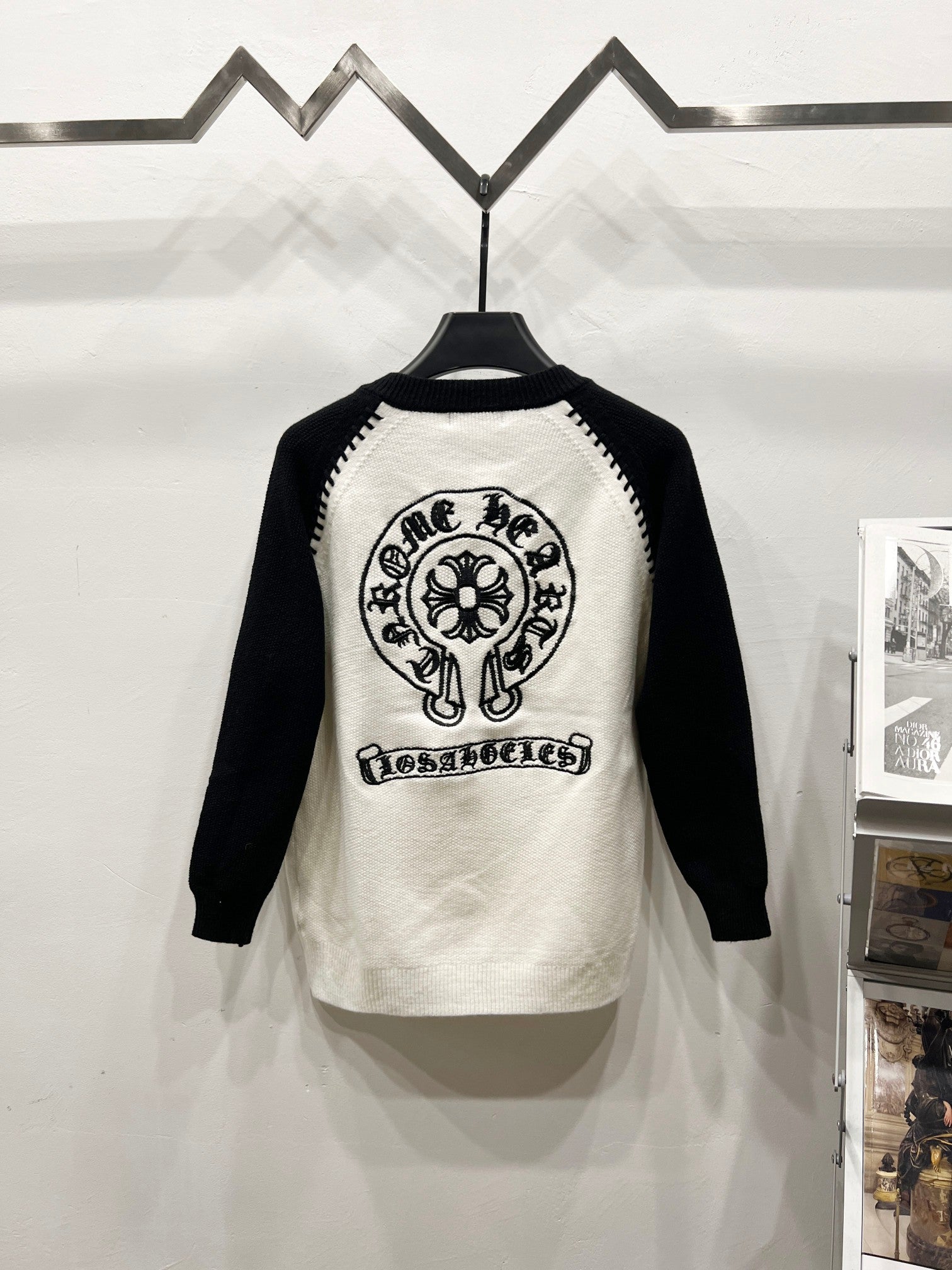 White raglan shirt with black sleeves and large back mascot graphic.