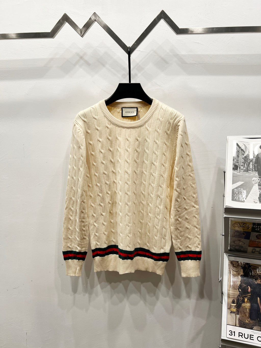 Cream cable-knit sweater with crew neck and multicolor striped hem and cuffs