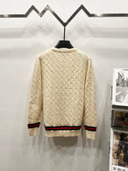 Cream cable-knit sweater, crew neckline, multicolor striped hem at back