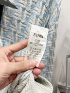 Fendi knit polo sweater care label card held in hand