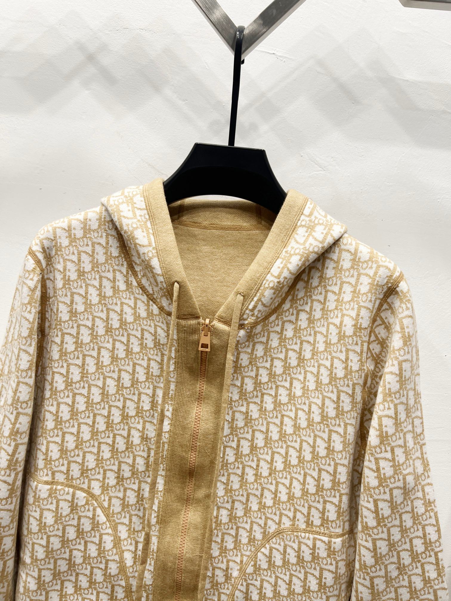 Beige hooded zip jacket with allover Dior logo pattern and front zip closure