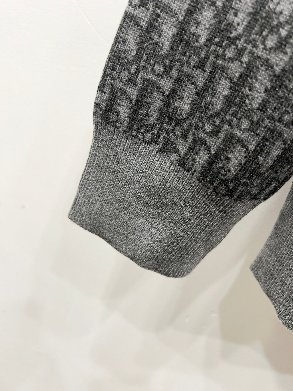 Grey ribbed hem of hooded zip jacket with repeating logo panel detail