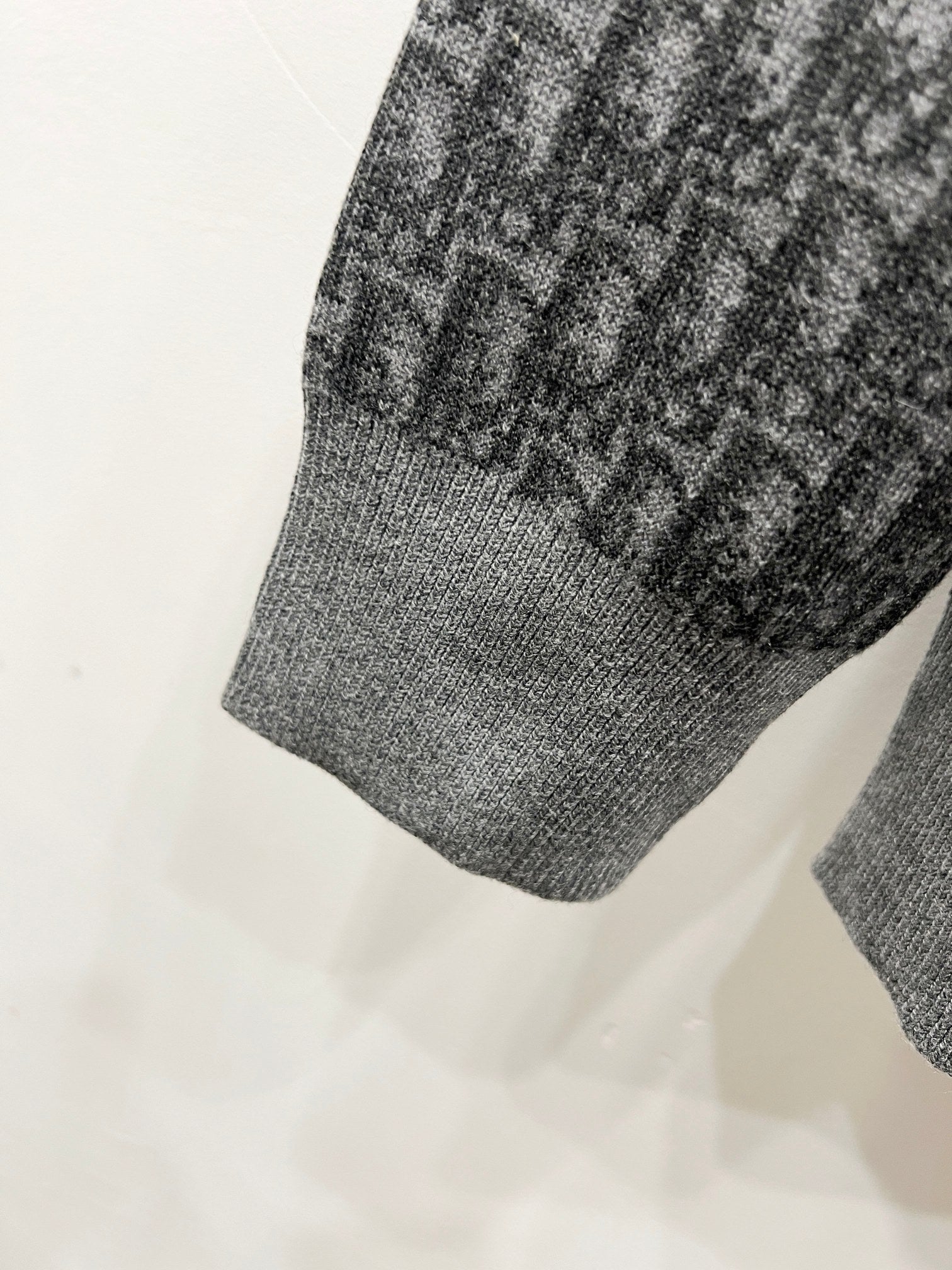 Grey ribbed hem of hooded zip jacket with repeating logo panel detail